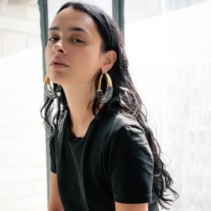 XL gold and clear bucket hoop earrings on model